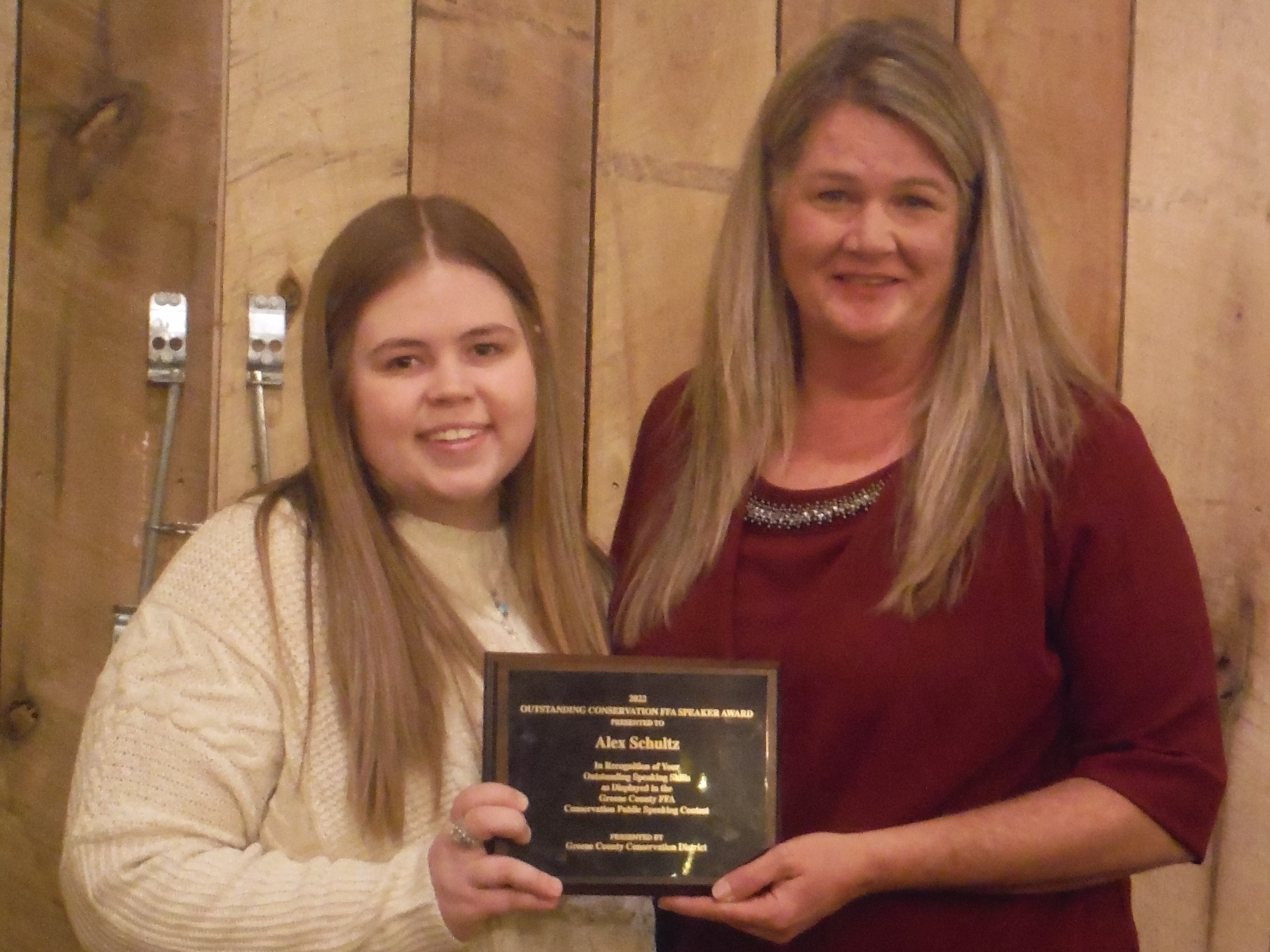 Lisa Snider., presented Alex Shultz, the 2022 Outstanding Conservation FFA Speaking at the Greene County Conservation DistrictÃ¢â‚¬â„¢s annual award ceremony on Wednesday, Dec. 14.